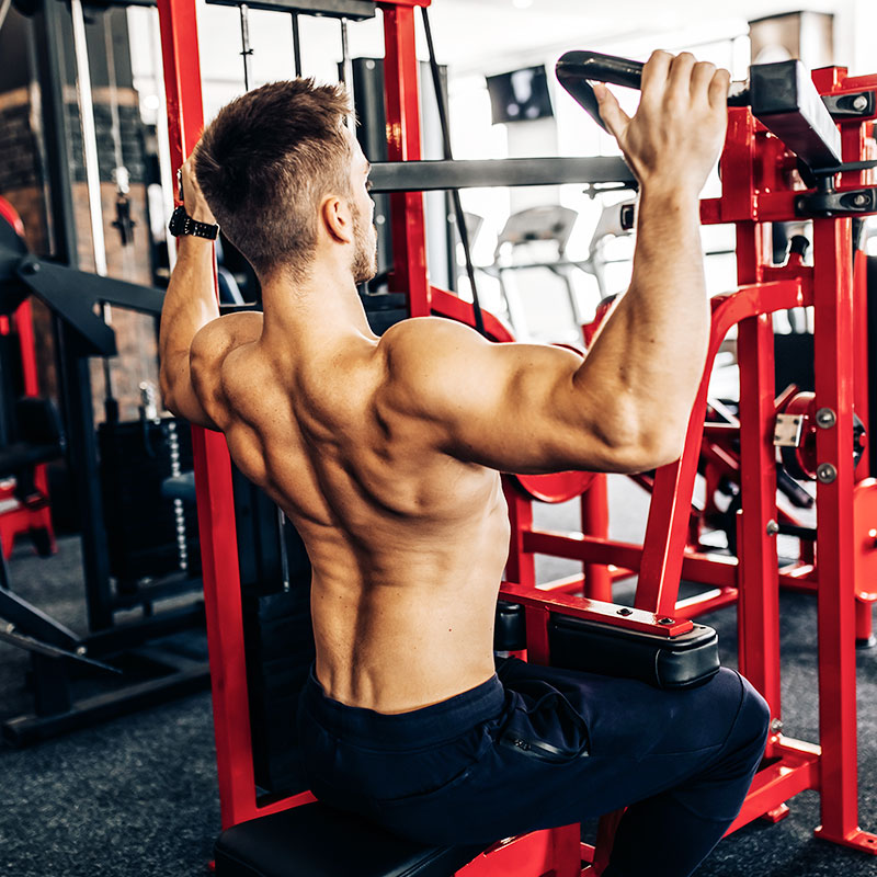 Male doing weighted pulldowns