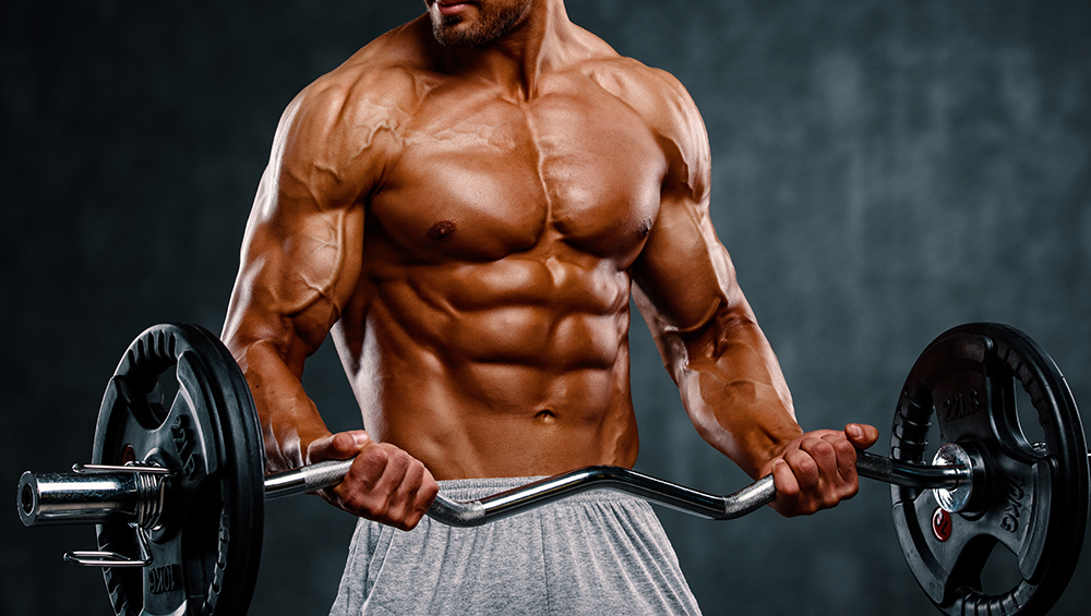 Muscular tanned guy doing a barbell curl